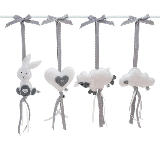 Four soft plush baby hanging ornaments on a white rod: a white bunny with gray ears and belly, a white heart with a gray center, a white sheep with gray face and legs, and a white cloud with gray details. Each ornament hangs from a gray ribbon tied in a bow.