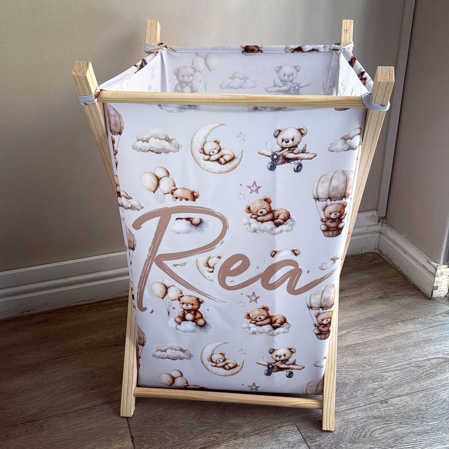 Baby changing table with teddy bear and cloud pattern on a wooden frame