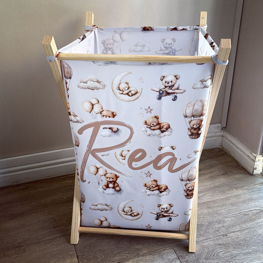 Baby changing table with teddy bear and cloud pattern on a wooden frame