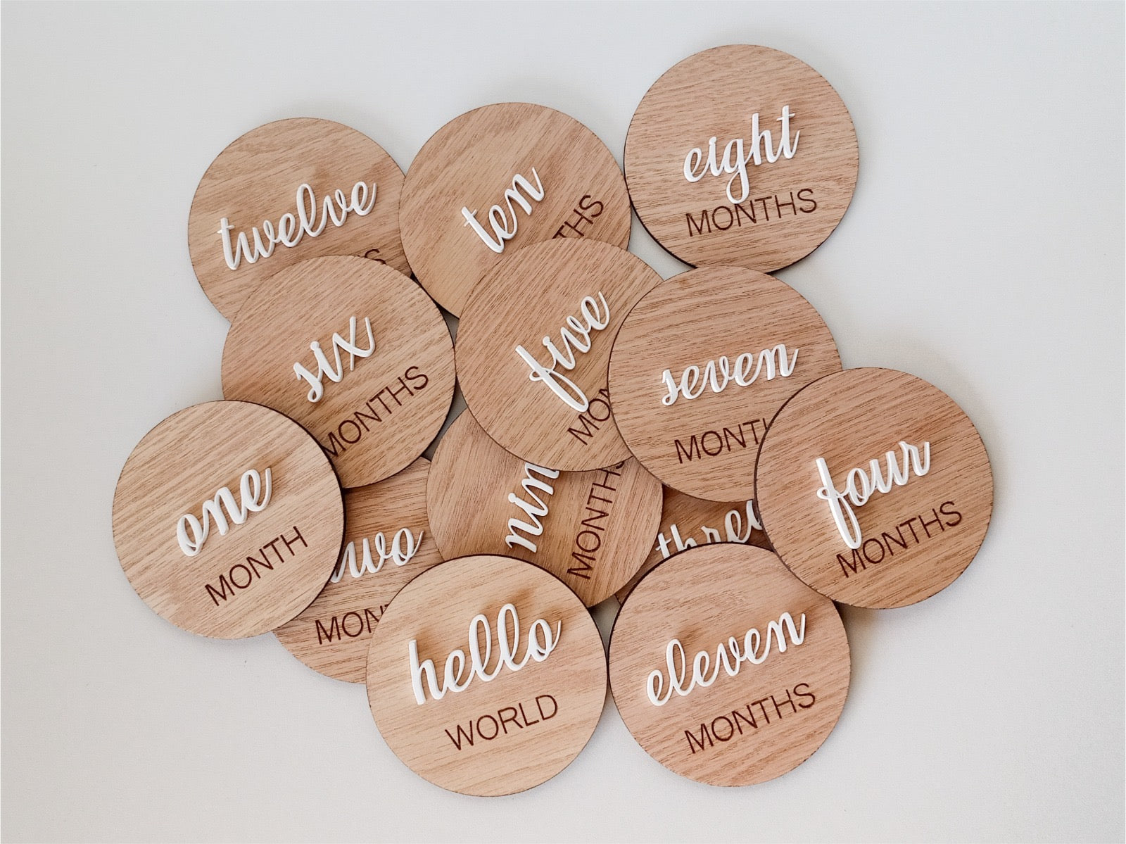 Wooden discs with milestone text on a light background