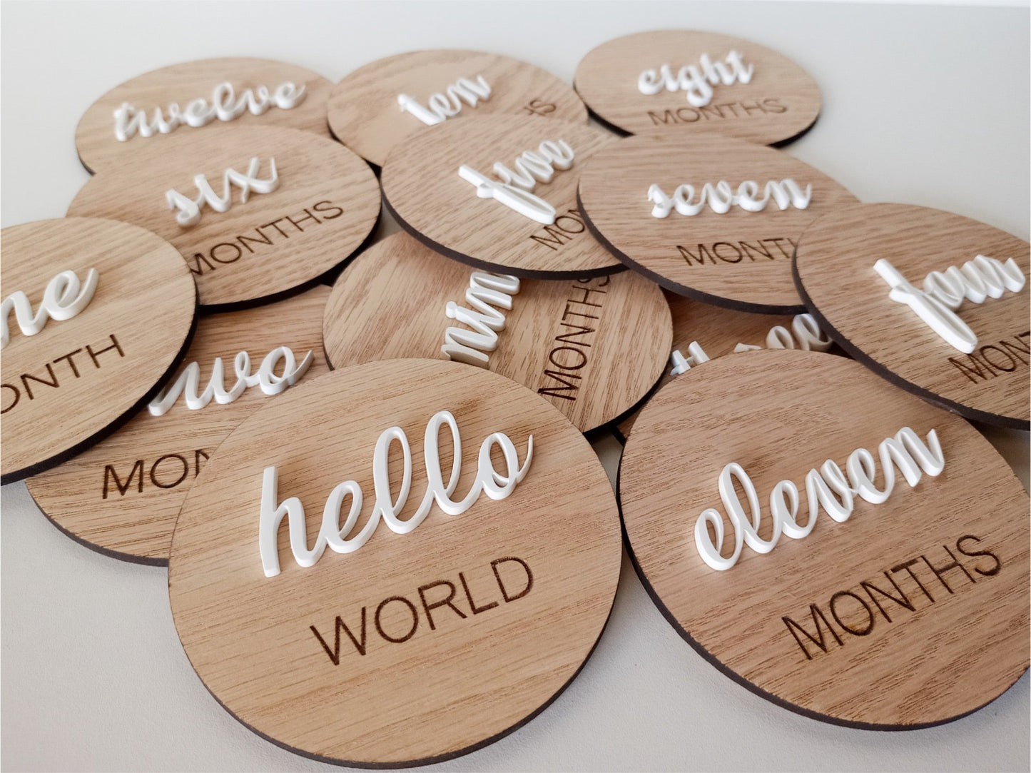 Wooden round milestone markers with numbers and phrases on a light background