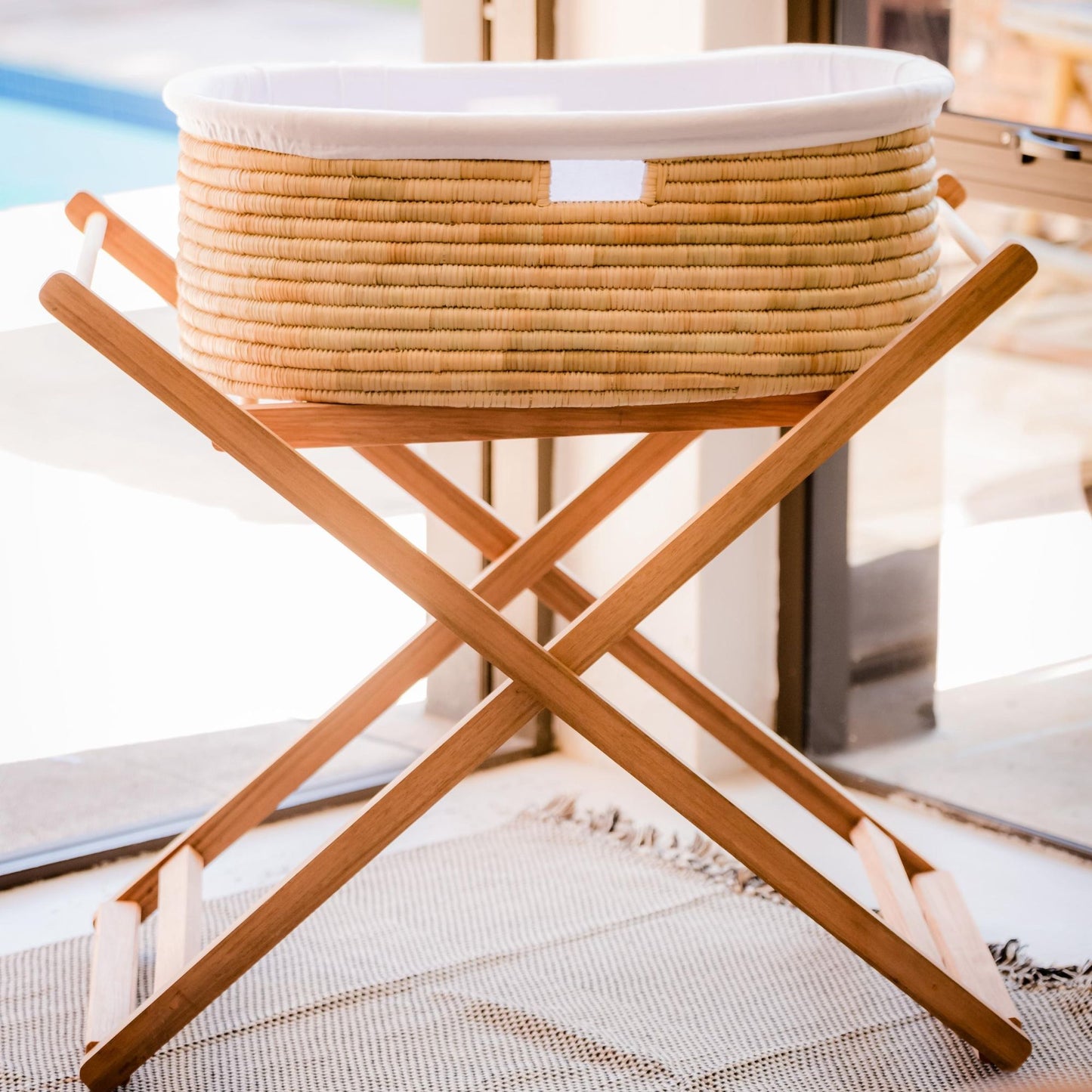 Wicker laundry basket on a wooden stand with a blurred background