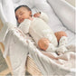 Newborn baby sleeping in a crib with white bedding and light clothing. | Baby Essentials | All Baby Products | Soft Spot Kids | South Africa