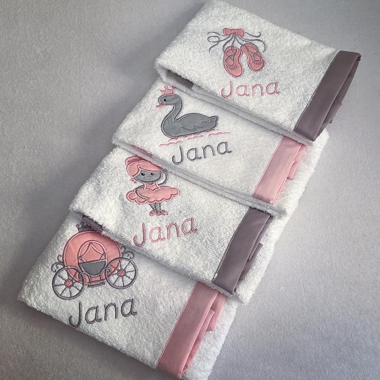 Set of towels with embroidered designs and 'Jana' text on a gray background
