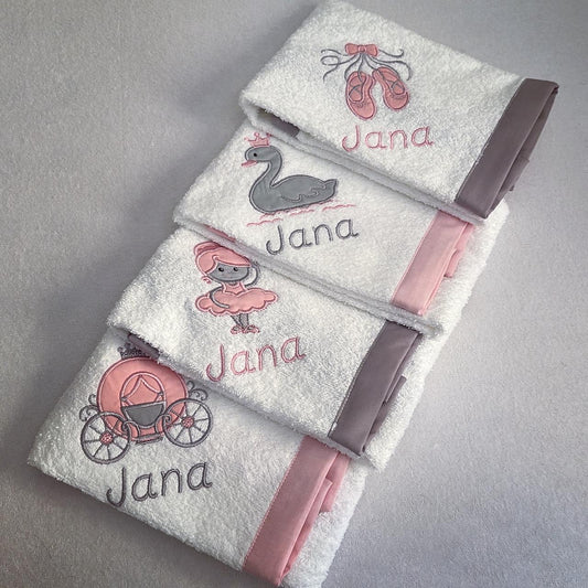 Set of towels with embroidered designs and 'Jana' text on a gray background