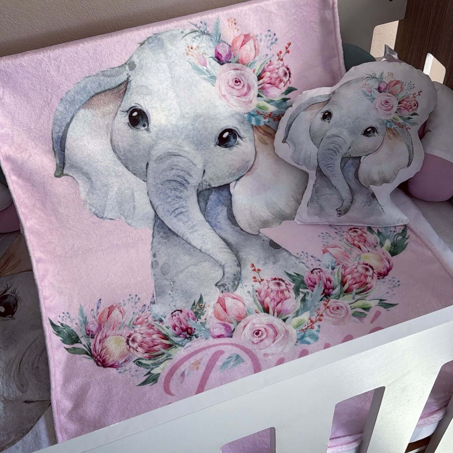 Decorative pillow with elephant design on a pink background