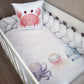 Crib with ocean-themed bedding featuring a pink crab, blue octopus, and orange jellyfish on a white background. | All Nursery Sets | Baby Bedding Sets South Africa | Soft Spot Kids | South Africa