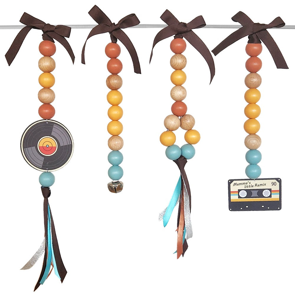 Decorative beads with ribbons and a record player on a white background
