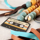 Colorful baby rattle with a cassette tape design label on a textured surface | Baby Essentials | All Baby Products | Soft Spot Kids | South Africa