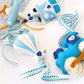 A set of small felt baby accessories, including a hot air balloon, a house, and a dinosaur, crafted in light blue, white, and dark blue, with matching patterned ribbons. | Baby Essentials | All Baby Products | Soft Spot Kids | South Africa